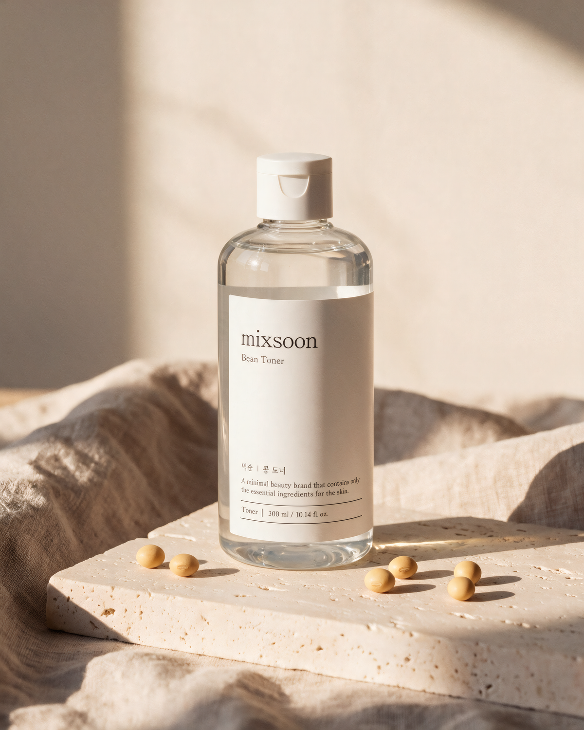 Mixsoon Bean Toner on a stone block with linen and a few soybeans