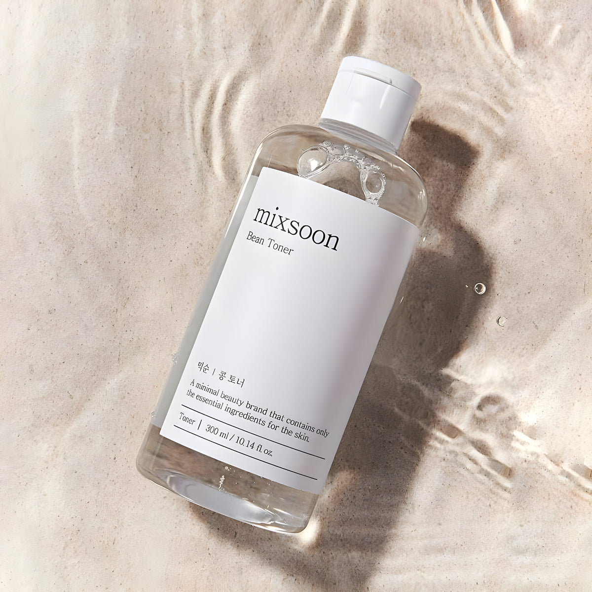 Mixsoon Bean Toner 300ml bottle on sand and water