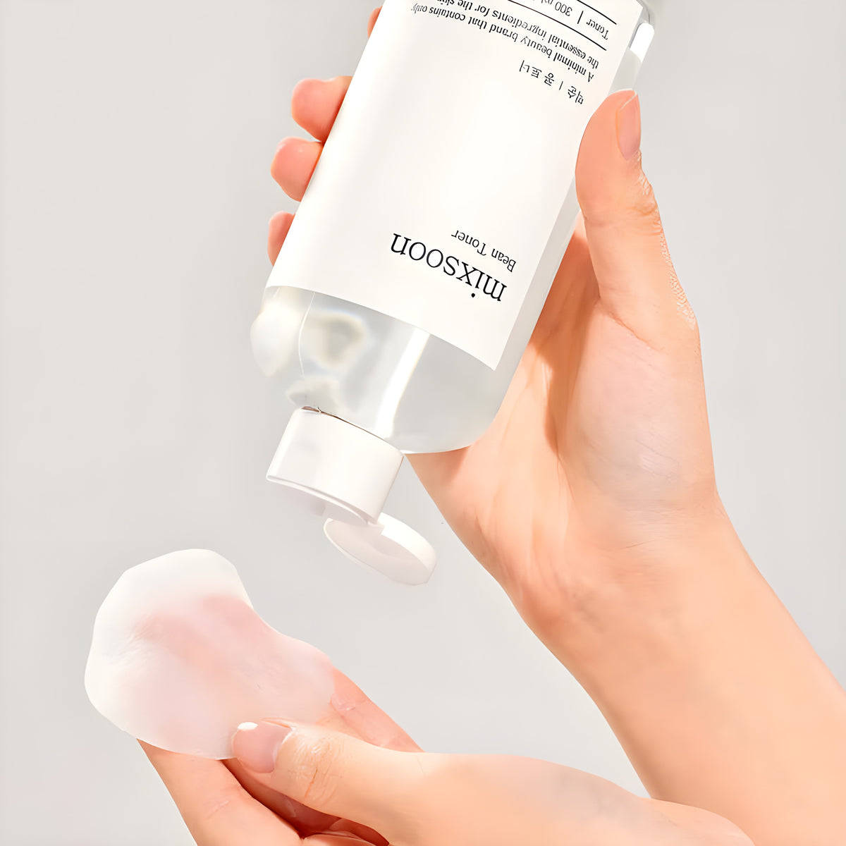 Pouring Mixsoon Bean Toner onto a cotton pad